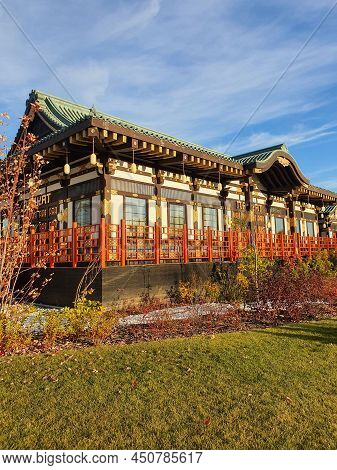 Asian-style Building. A Chinese House With A Curved Roof. The Concept Of Asia
