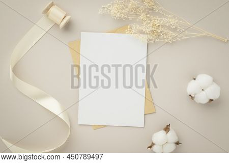 Blank Greeting Card Invitation Mockup 5x7 On Brown Envelope With Dried Flowers On Beige Background, 