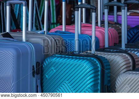 Bright  Colorful Rows Of Suitcases With Extended Handles And Different Sizes Are On Sale In Front Of