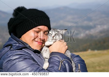 Slavsko, Lviv / Ukraine - October 07 2018: Woman Hugging Cat Outdoor