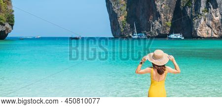 Woman Tourist In Yellow Swimsuit And Hat, Happy Traveller Sunbathing At Maya Bay Beach On Phi Phi Is