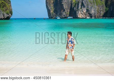 Happy Tourist Man At Maya Bay Beach On Phi Phi Island, Krabi, Thailand. Landmark, Destination Southe
