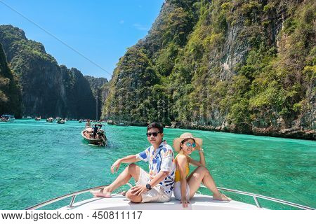 Couple Tourist On Boat Trip, Happy Traveller Relaxing At Pileh Lagoon On Phi Phi Island, Krabi, Thai