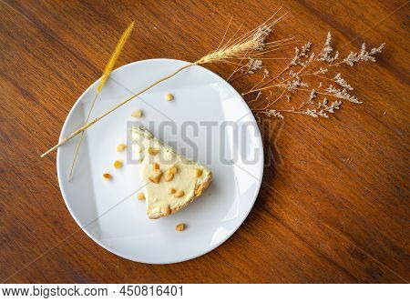 Coconut Cream Pie In The White Dish On The Wood Table That Topping With Macademia. Shooting In The S