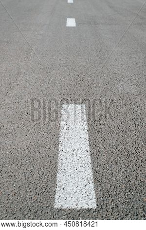 Vertical Dividing White Stripes On Asphalt. Road Marking Line Outdoors, Perspective View.