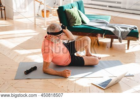 Elderly Aged Male Exercising With Dumbbells During Online Training. Old Person Man Pensioner Healthy