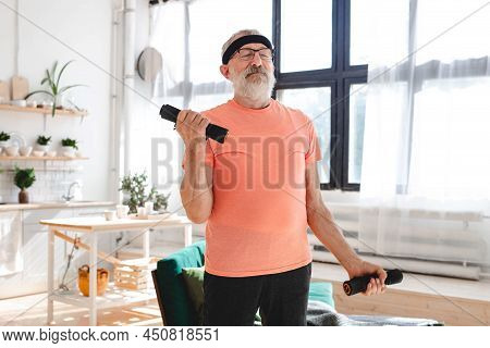 Elderly Aged Male Exercising With Dumbbells During Online Training. Old Person Man Pensioner Healthy