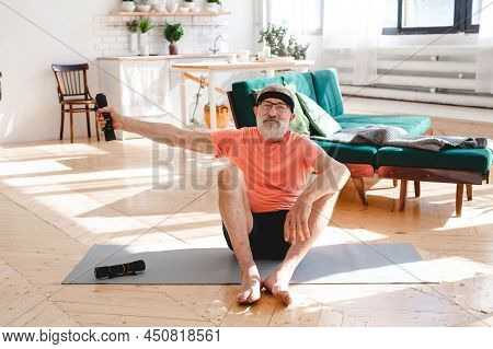 Elderly Aged Male Exercising With Dumbbells During Online Training. Old Person Man Pensioner Healthy