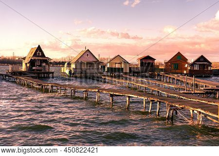 Sunset On Floating Village Bungalows In Bokod Hungary With Wooden Pier Walkway