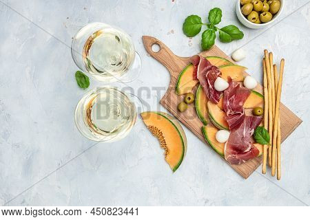 Fresh Melon With Prosciutto And Basil. Antipasti, Traditional Spanish And Italian Appetizer. Top Vie