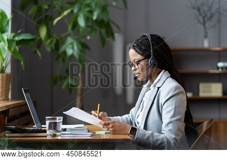 African American Female Ceo Executive In Wireless Headset With Mic Discussing Project Results With R