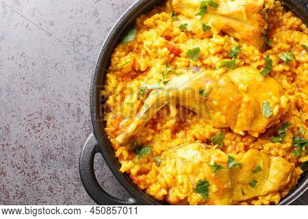 Traditional Spanish Dish Conejo Con Arroz That Combines Rice With Rabbit Meat Closeup In The Pan On 