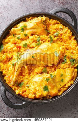 Typical Spanish Rice With Rabbit Arroz Con Conejo Closeup In The Pan On The Table. Vertical Top View