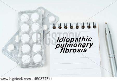 Medical Concept. On A White Surface Are Pills In A Package, A Pen And A Notepad With The Inscription