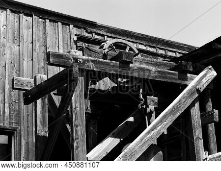 Old Mineshaft Hoist On An Old Abandoned Wooden Building