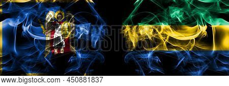 Kyiv, Kiev Vs Gabon, Gabonese, Gabonian Flag. Smoke Flags Placed Side By Side Isolated On Black Back