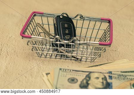 Car Keys In A Small Shopping Cart. The Concept Of Buying A Car