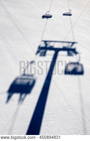 Shadow Of Ski-lift Chair On Slope At Ski Resort.