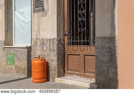 Felanitx, Spain; March 07 2022: Empty Butane Canister At The Door Of A House, Waiting For The Butane