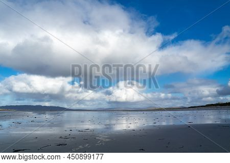 Cummulus Clouds Above The Beach In Ireland.