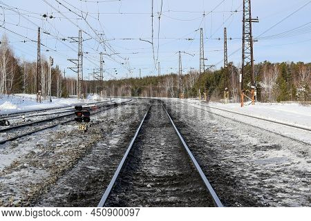 Railway Tracks Go Into The Distance Beyond The Horizon, Wiinter Landscape.