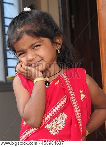 Closeup Of Beautiful Indian Girl Kid Traditionally Dressed To Distribute Makara Sankranti Or Pongal