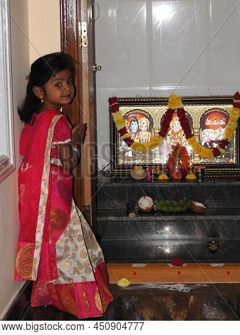 Closeup Of Beautiful Indian Girl Kid Traditionally Dressed To Distribute Makara Sankranti Or Pongal