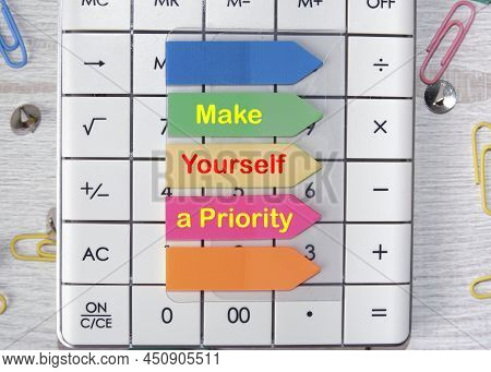Make Yourself A Priority Text Is Written On The Stickers That Are On The Calculator.