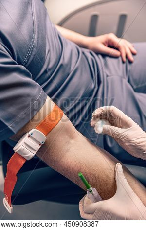 Nurse Disinfecting Male Arm Before Blood Test.