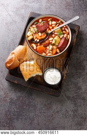 Hungarian Bean Goulash Soup Babgulyas Closeup In The Plate On The Wooden Tray. Vertical Top View Fro
