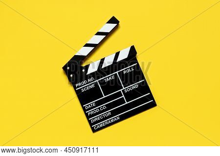 Clapperboard For Shooting Video Footage Takes On A Yellow Background