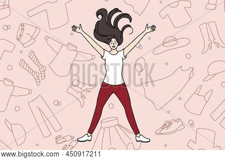 Overjoyed Young Girl Lying Among Clothes Excited With Shopping And Purchase. Smiling Woman Shopaholi