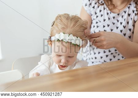 Mother Helps To Put On Cochlear Implant For Her Deaf Little Daughter. Hearing Aid And Deafness Conce