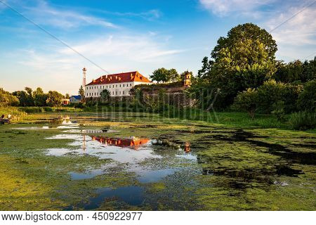 Scenic View Of The Medieval Dubno Castle Reflected In Ikva River, Dubno, Rivne Region, Ukraine. Popu
