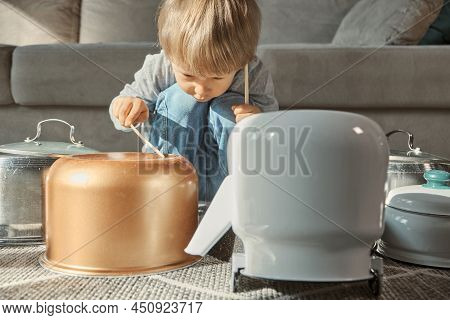 Child Drummer Having Fun Drum Playing On Kitchen Pans At Home