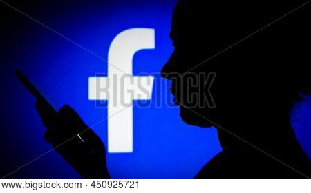 March 14, 2022, Brazil. In This Photo Illustration The Facebook Logo Seen In The Background Of A Sil