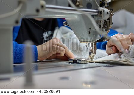 Needle Of The Sewing Machine Is In Motion. Close-up Of The Sewing Machine Needle Moving Up And Down 