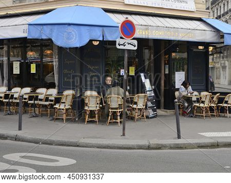 Paris, France - March 5, 2022: Few People At Exterior Terrace Having Breakfast On The Morning  In Pa