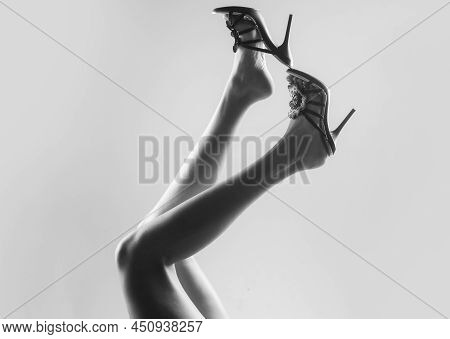 Sexy Woman Slim Legs. Undress Shoes. Trendy Fashion.