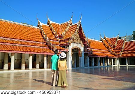 Couple Admiring The Amazing Phra Rabiang Of Wat Benchamabophit Marble Temple, Historic Place In Bang