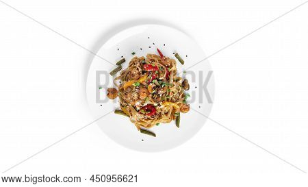 Wok Noodles With Seafood Isolated On A White Background. Pasta With Shrimp And Mussels.
