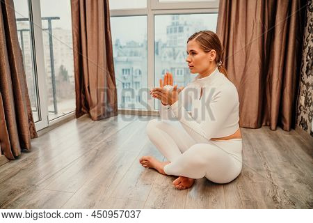 Athletic Slim Caucasian Woman Doing Thigh Self-massage With A Massage Ball Indoors. Self-isolating M
