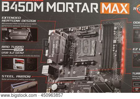 Msi B450 Mortal Max Motherboard Against A Gray Background. Black Box With The New Computer Hardware.