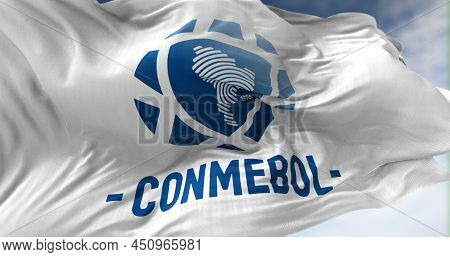 Luque, Par, March 2022: Close-up View Of The White Flag With The Conmebol Logo Waving In The Wind. C