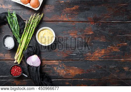 Fresh Asparagus Eggs And French Dressing Ingredients With Dijon Mustard, Onion Taragon On Dark Woode