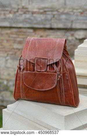 Orange Leather Backpack On The Snone Monument