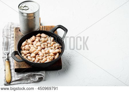 Canned White Beans Set, With Metal Can, In Cast Iron Frying Pan, On White Stone  Surface, With Copy 