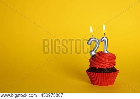 Delicious Cupcake With Number Shaped Candles On Yellow Background, Space For Text. Coming Of Age Par