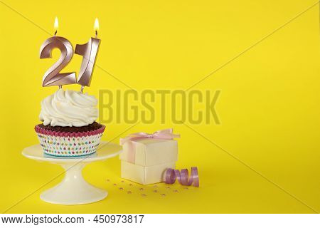 Delicious Cupcake With Number Shaped Candles On Yellow Background, Space For Text. Coming Of Age Par