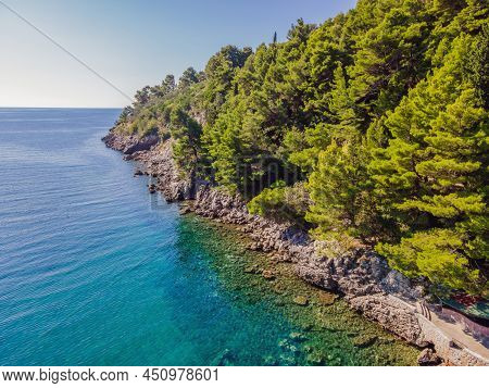 Picturesque Sea Adriatic Coast Of Montenegro. Turquoise Mediteran Sea And Rocky Shore With Evergreen